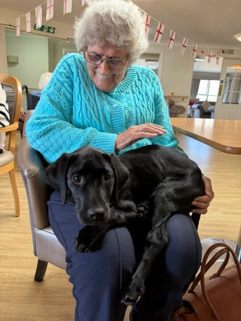 Akira spending time with a resident during a care-setting visit.